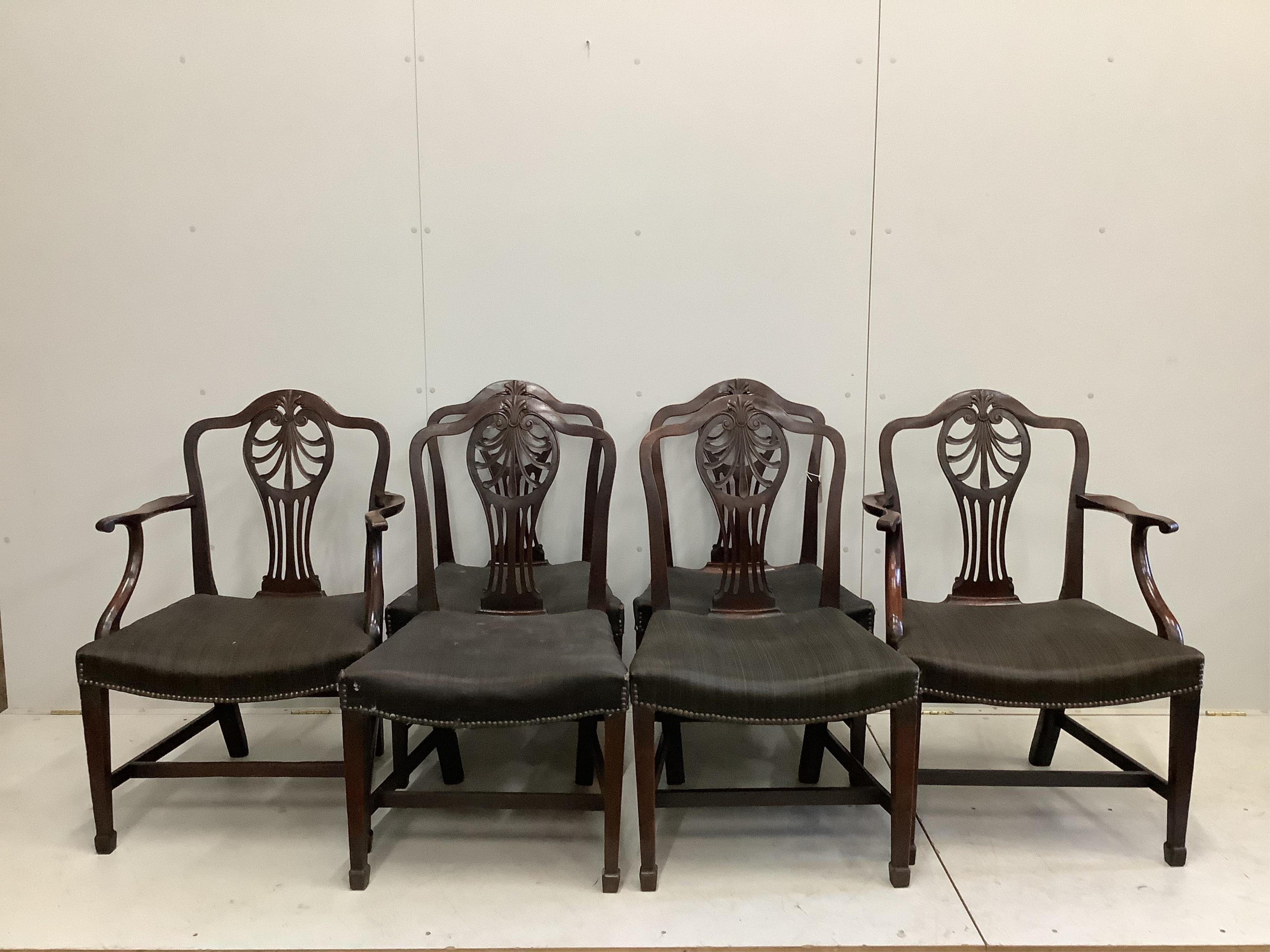 A set of six George III mahogany dining chairs, two with arms. Condition - fair, upholstery poor